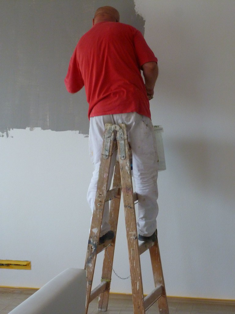 Painter applying a fresh coat to an interior wall