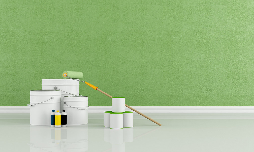 Premium paint tins and roller against a fresh wall colour
